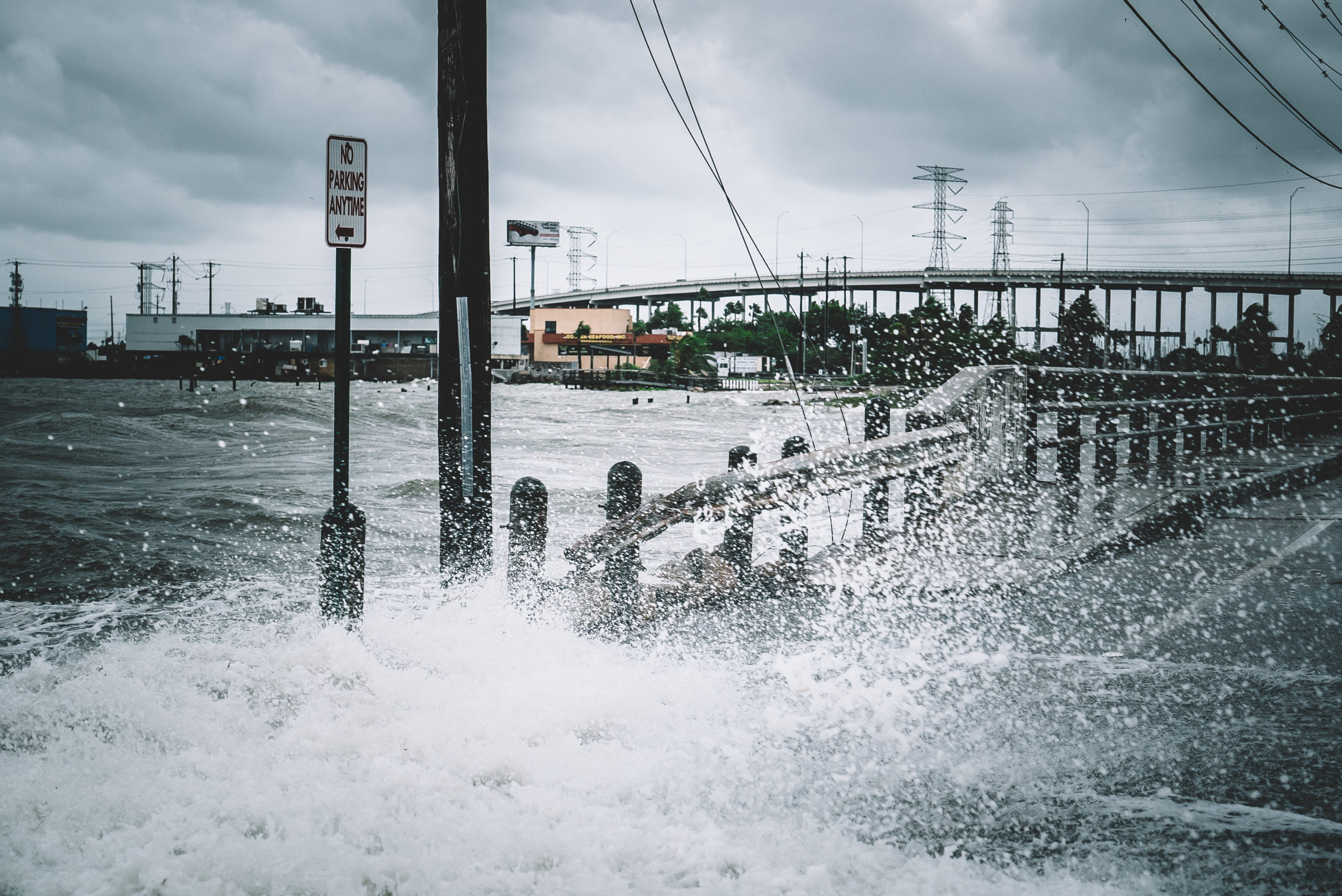 water coming into streets over the sea barrier wall during a hurricane